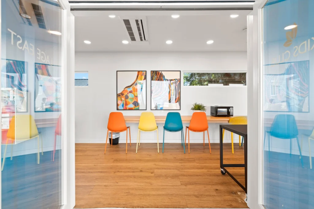 Front entrance of kids club with view of a long table and chairs