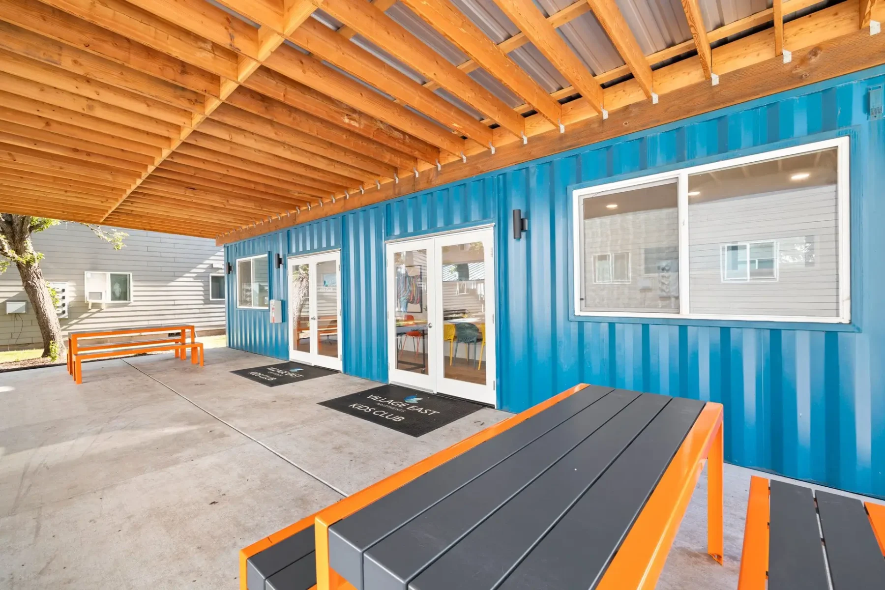 Covered patio outside of the kids club with picnic tables