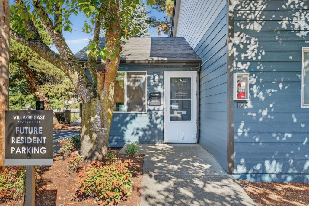 Exterior of leasing office with glass door and sign for Future Resident Parking