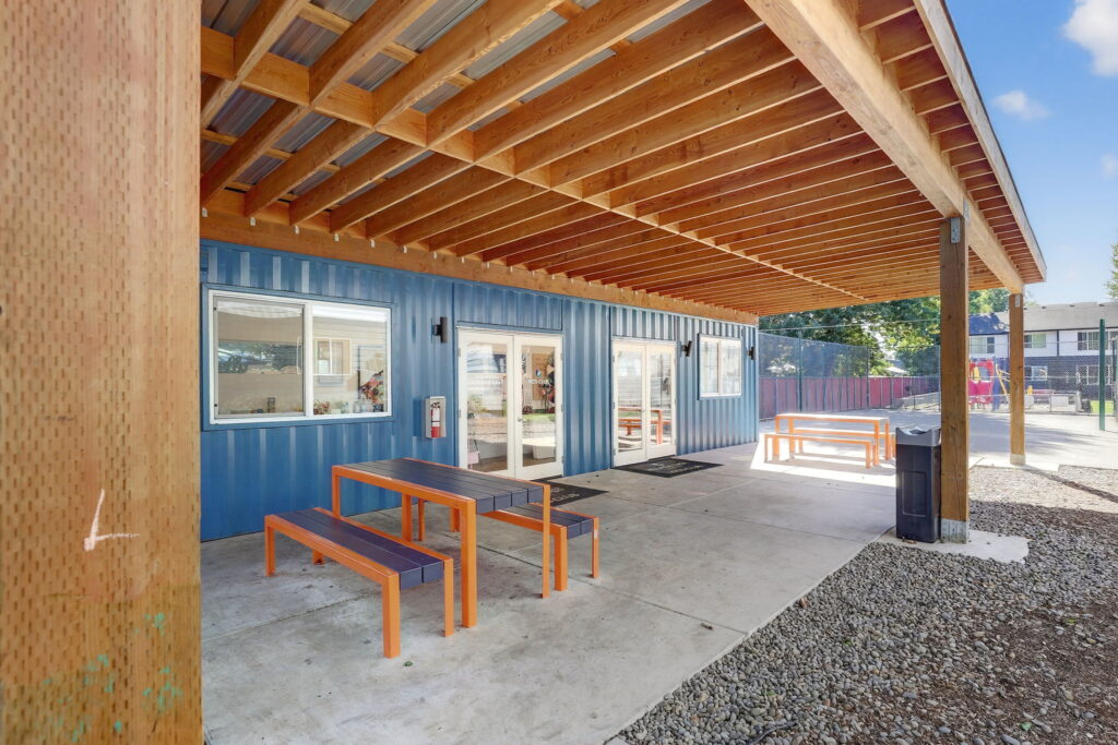 Covered patio outside the kids club with picnic table