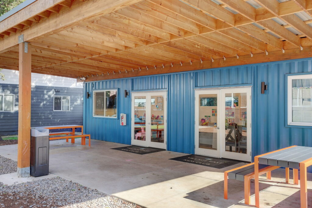 Covered patio outside the kids club with picnic table